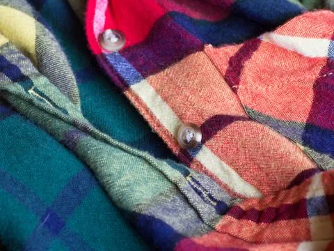 Plastic button on a shirt Stock Photos