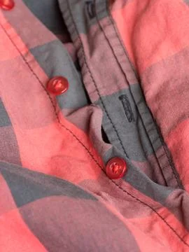 Plastic button on a shirt Stock Photos