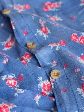 Plastic button on a shirt Stock Photos