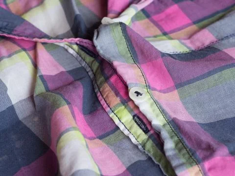 Plastic button on a shirt Stock Photos