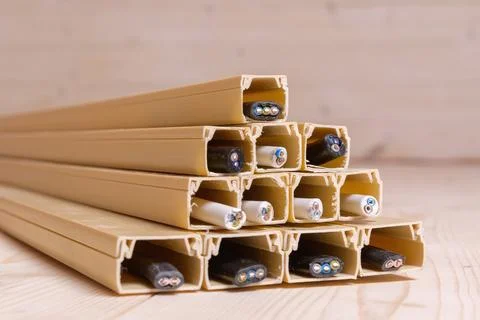 Plastic cable channels filled with various electric wires form a pyramid on a Stock Photos