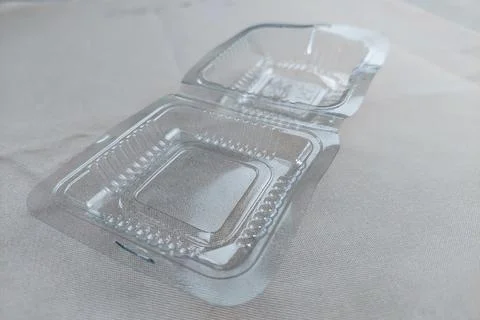 Plastic cake box on white table Stock Photos