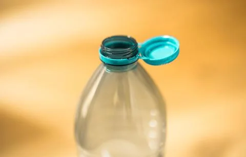 Plastic cap connected to a plastic bottle. Bottle design with the cap attache Stock Photos