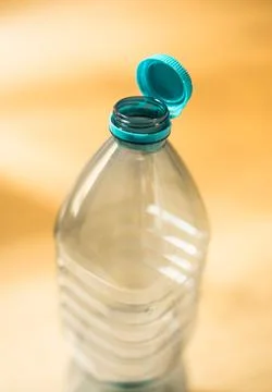 Plastic cap connected to a plastic bottle. Bottle design with the cap attache Stock Photos