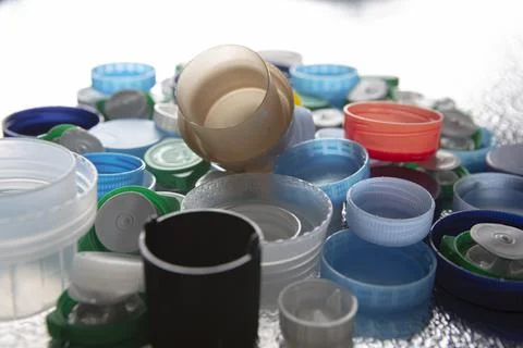 Plastic caps of different sizes and colors on a silver background Stock Photos