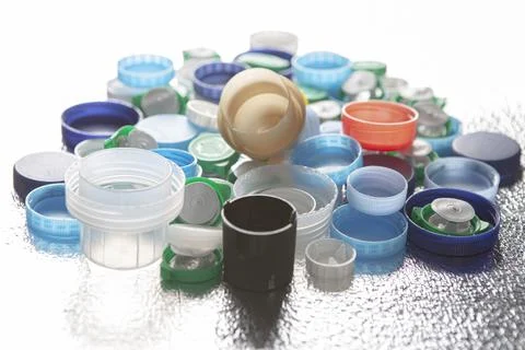 Plastic caps of different sizes and colors on a silver background Stock Photos