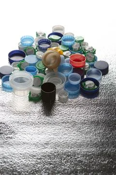 Plastic caps of different sizes and colors on a silver background Stock Photos
