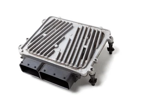 A plastic car engine control unit with metal elements on a white isolated bac Stock Photos
