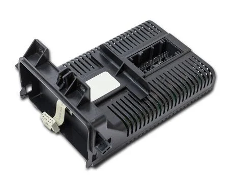 Plastic car engine control unit with plastic elements on a white isolated bac Stock Photos