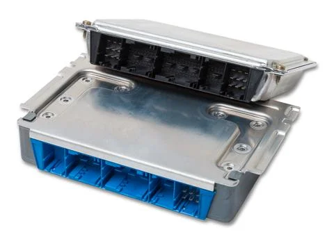 Plastic car engine control unit with metal elements on a white isolated backg Stock Photos