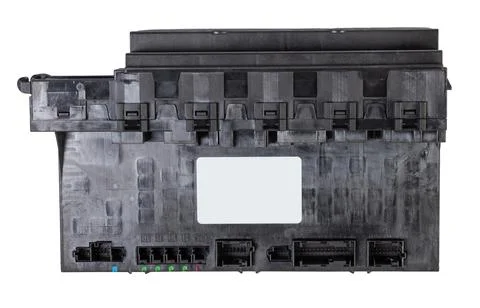 Plastic car engine control unit with metal elements on a white isolated backg Stock Photos