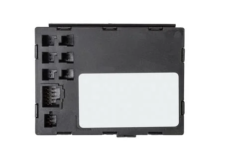 A plastic car engine control unit with metal elements on a white isolated bac Stock Photos