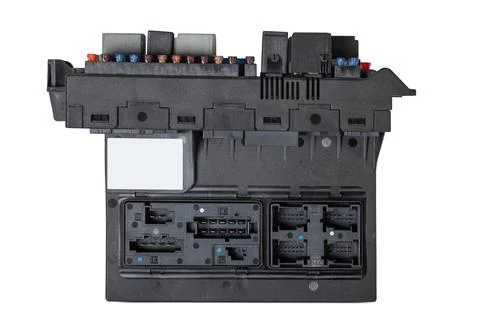 A plastic car engine control unit with metal elements on a white isolated bac Stock Photos