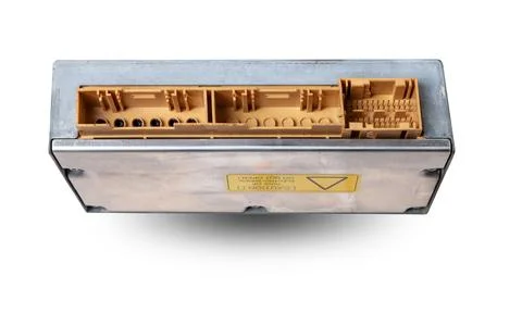 Plastic car engine control unit with metal elements on a white isolated backg Stock Photos