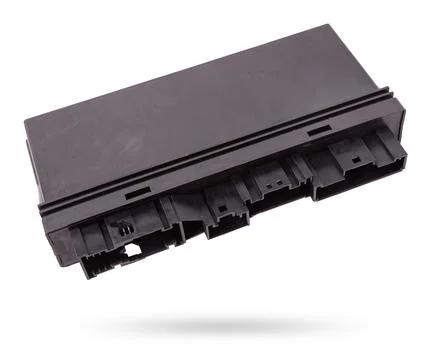 Plastic car engine control unit with metal elements on a white isolated bac.. Stock Photos
