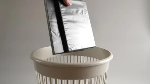 The plastic of the CD box is thrown into the trash for recycling Stock Footage 260531634