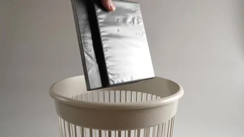 The plastic of the CD box is thrown into the trash for recycling. Slow motion Stock Footage 261030144