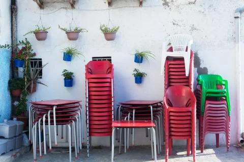 Plastic chairs on the backyard of cafe Stock Photos