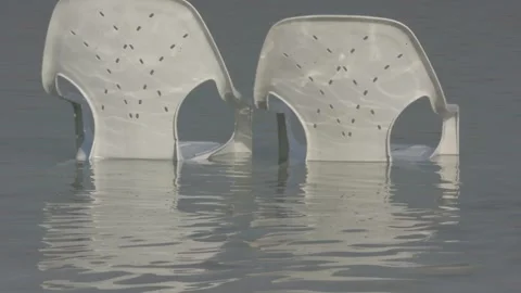 Plastic chairs in dead sea Stock Footage 163079820