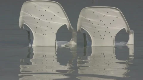 Plastic chairs in dead sea Stock Footage 163079859