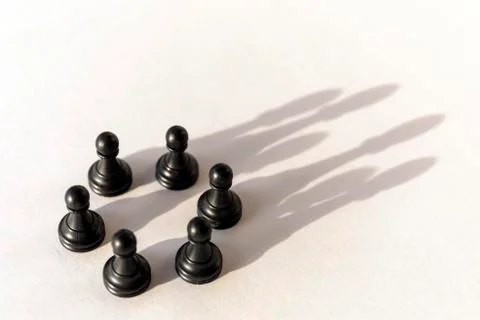 Plastic chess pawn circle with shadow shaped as crown on white background. Te Stock Photos