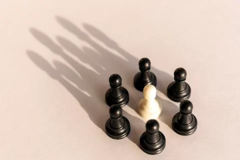 Plastic chess pawn circle with shadow shaped as crown on white background. Te Stock Photos