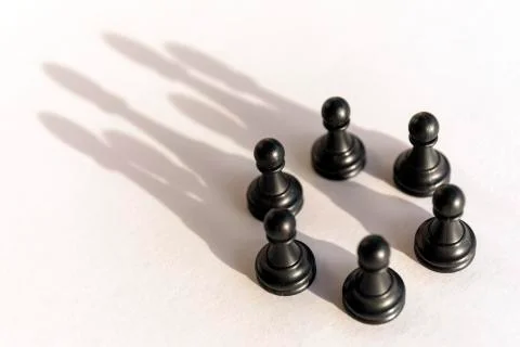 Plastic chess pawn circle with shadow shaped as crown on white background. Te Stock-Fotos