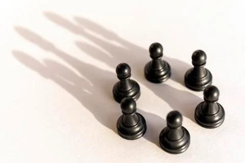 Plastic chess pawn circle with shadow shaped as crown on white background. Te Stock Photos