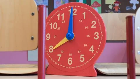 Plastic children's analog clock in the classroom for interactive learning hours Stock Photos