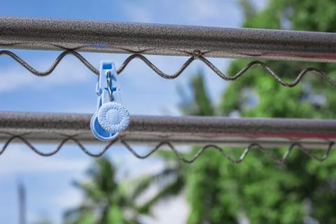 Plastic clothespin on a clothesline. Stock Photos