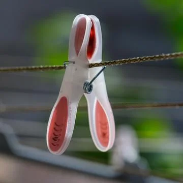Plastic Clothespin on Rope Clothesline Stock Photos
