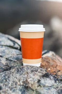 Plastic coffee cup on the rocks Stock Photos