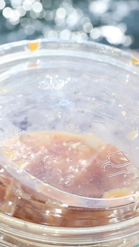 Plastic Coffee Cup by the Sea Closeup (Vertical Video) Stock Footage 323940443
