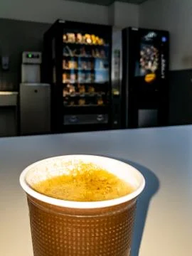 Plastic coffee cup of vending machine standing on table Stock Photos