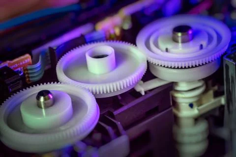Plastic cogs and gears inside printer. Stock Photos