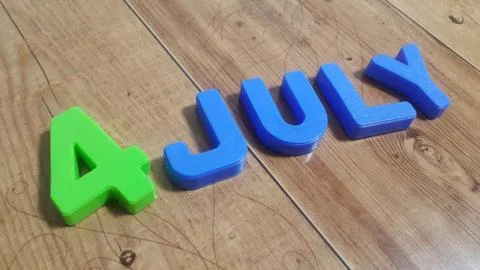 Plastic colored alphabets making words 4 july are placed on a wooden floor Stock Photos