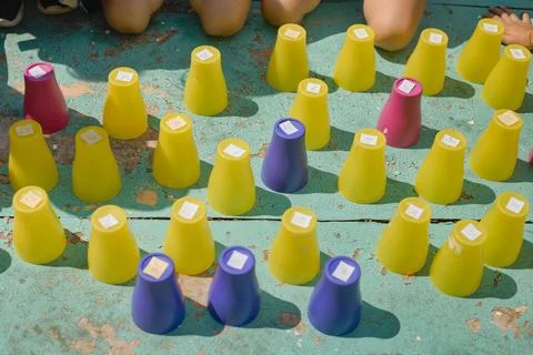 Plastic colored numbered cups turned upside down on a table prepared for th.. Stock Photos
