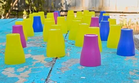 Plastic colored numbered cups turned upside down on a table prepared for th.. Stock Photos
