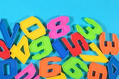 Plastic colored numbers on a blue background Stock Photos