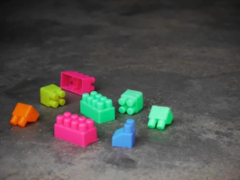 Plastic colorful blocks presented on cemented floor 스톡 사진