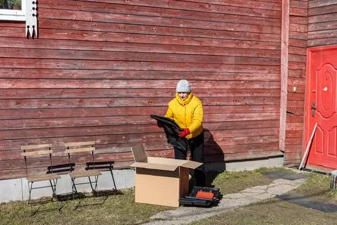 Plastic compost container for self assembly standing beside homeowner remov.. Fotos de archivo