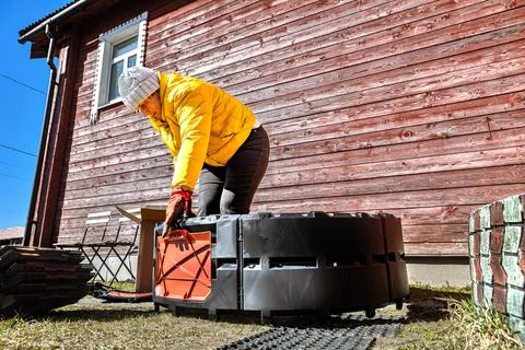 Plastic compost system for self assembly standing on lawn while homeowner f.. Stock Photos