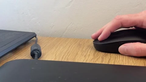 Plastic computer mouse snapping, sliding and tapping against a wooden table Stock Footage 330397693