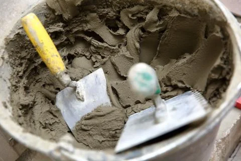 A plastic construction bucket with cement based glue ready to be used for gluing 写真素材