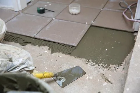 A plastic construction bucket with cement based glue ready to be used for gluing 写真素材