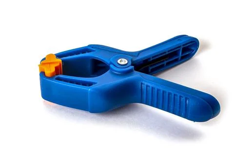 Plastic construction clamp with spring clip, insulated on a white background Stock Photos
