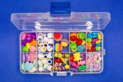 Plastic container with colored round buttons jewelry for clothes separate cel Stock Photos