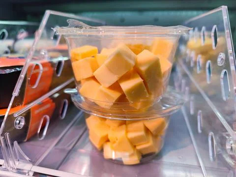 Plastic container with cubes of cheese in it is being sold without visible marks Stock Photos