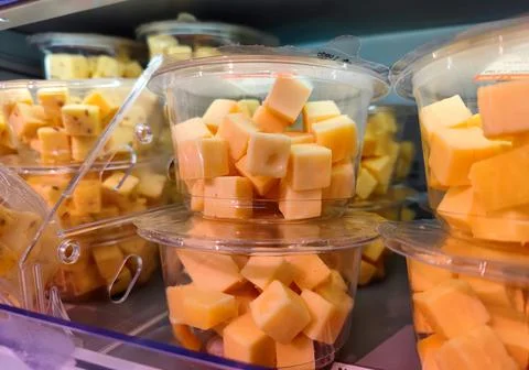 Plastic container with cubes of cheese in it is being sold without visible marks Stock Photos
