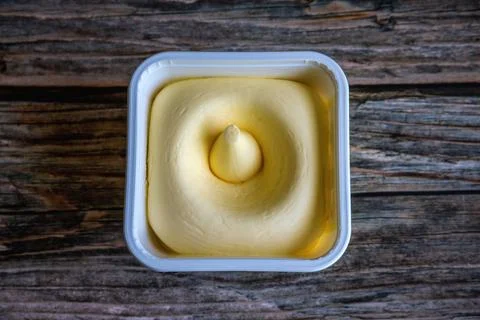 A plastic container filled with vegetable oil spread. Stock Photos